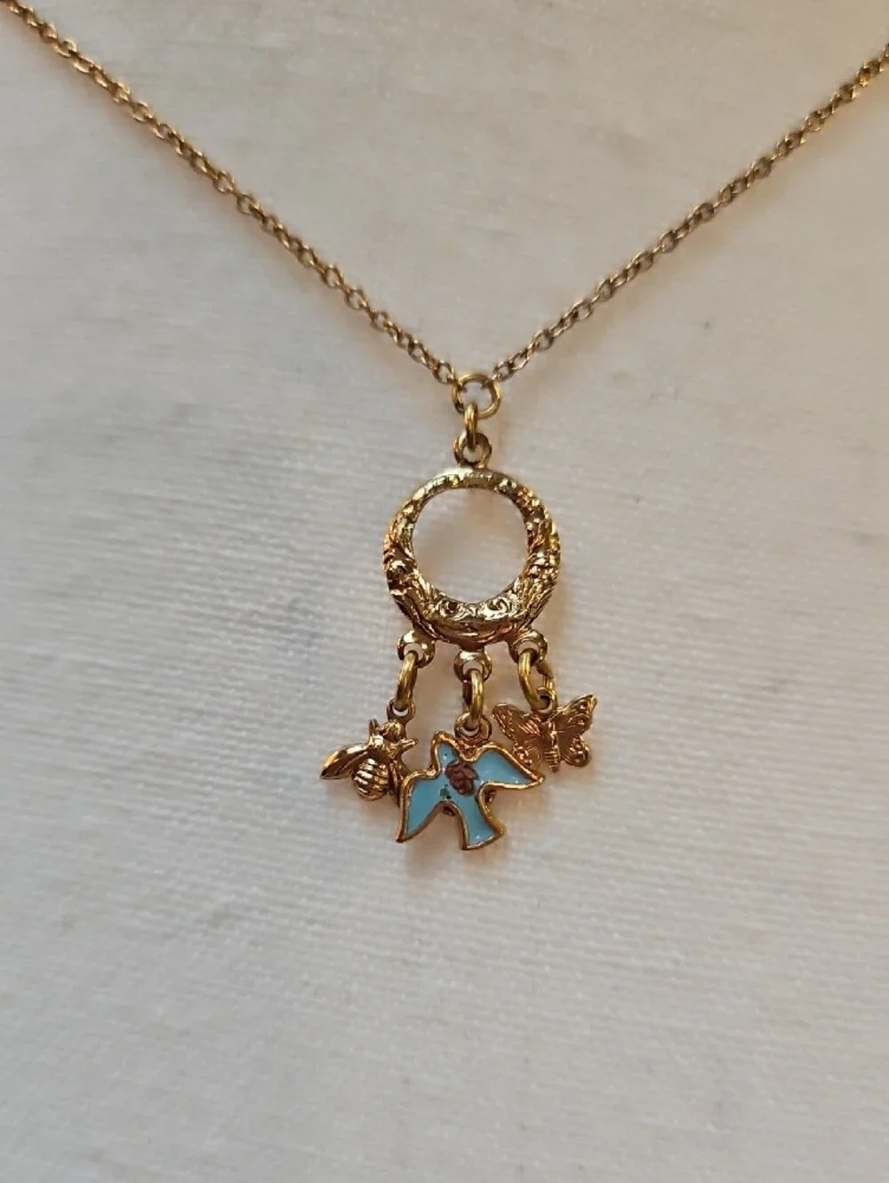 1928 Gold-Tone Circle Necklace with Blue Enamel Bird Bee Butterfly Charms